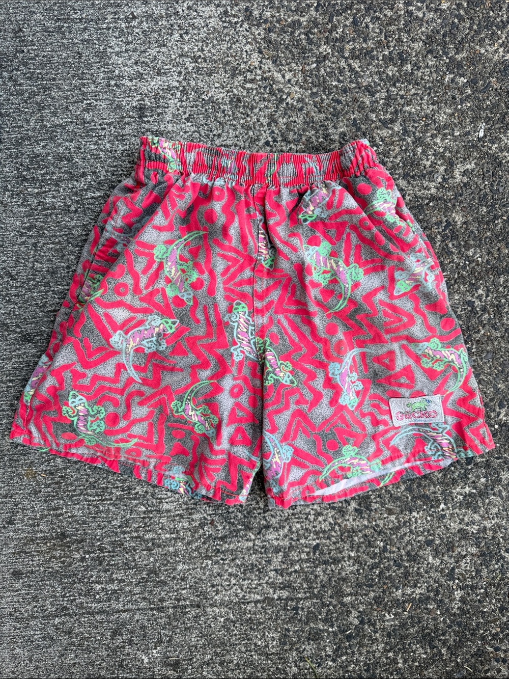 Vintage Gecko Hawaii board shorts neon pink and grey lizard graphic pattern.